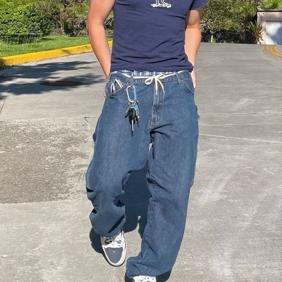 Male model wearing y2k baggy blue jeans